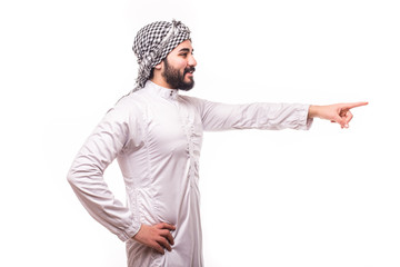 Young arab man pointed side wearing in traditional abaya clothes isolated on white background