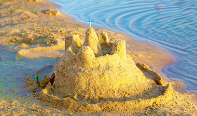 Sand castle on a tropical sea beach.