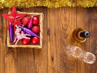 Christmas decorations on a wooden table, Two champagne glasses and a bottle of champagne. Top view,