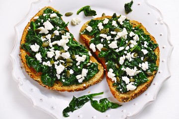 Spinach and feta toasts on the white background