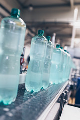 Bottling plant - Water bottling line for processing and bottling pure spring water into small bottles. Selective focus.