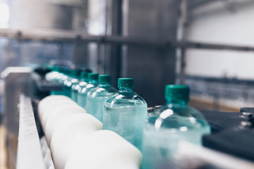 Bottling plant - Water bottling line for processing and bottling pure spring water into small bottles. Selective focus.