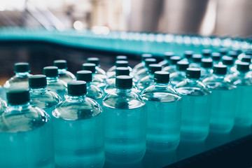 Bottling plant - Water bottling line for processing and bottling pure spring water into small bottles. Selective focus.
