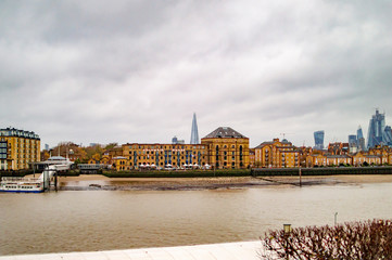 Canary wharf with thames in london and the small towers at other side