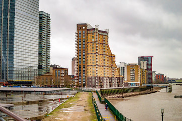 Canary wharf with thames in london with tall buildings on the banks