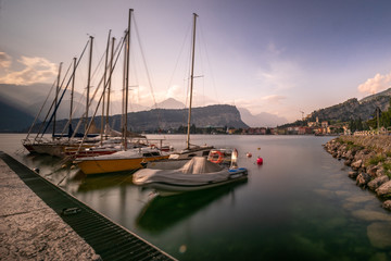 Sailing, boats, in a harbor. Lago di garda, garda lake, torbole, boat on a lake in the evening sun. calm, chill, faded water