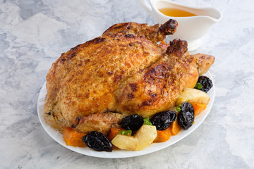 Roast Turkey, chicken, decorated with pumpkins, prunes, apples. thanksgiving day. slow food