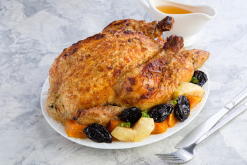 Roast Turkey, chicken, decorated with pumpkins, prunes, apples. thanksgiving day. slow food