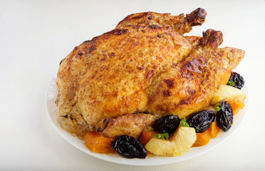 Roast Turkey, chicken, decorated with pumpkins, prunes, apples. thanksgiving day. slow food
