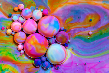 Macro photography of colorful bubbles in some fluids producing vibrant fleeting microworlds that are eternalized in a picture.