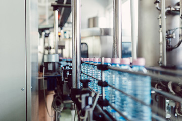 Bottling plant - Water bottling line for processing and bottling carbonated water into bottles. Selective focus.