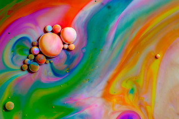 Macro photography of colorful bubbles in some fluids producing vibrant fleeting microworlds that are eternalized in a picture.