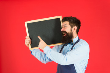 advertising concept. great cuisine. cooking by recipe. welcome. Restaurant or cafe advertising. bearded hipster cook in apron. happy man chef with blackboard, copy space. menu board. advertising