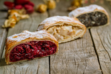 Cherry strudel, apple strudel on a wooden board