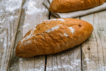 round black bread on wooden background