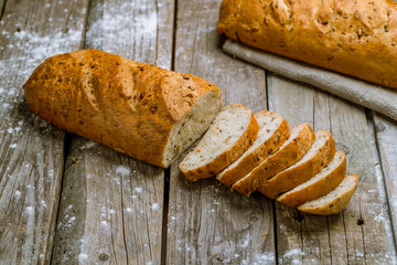 white bread with bran on wooden background