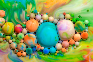 Fototapeta na wymiar Macro photography of colorful bubbles in some fluids producing vibrant fleeting microworlds that are eternalized in a picture.