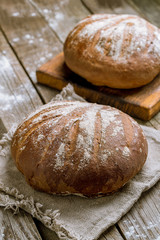 round black bread on wooden background