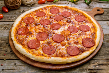 Pepperoni pizza on plate on board