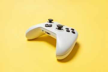 White joystick gamepad, game console on yellow colourful trendy modern fashion pin-up background. Computer gaming competition videogame control confrontation concept. Cyberspace symbol © Юлия Завалишина