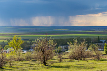 Fototapeta na wymiar The steppe before the rain. Storm front over the fields. Element captures the outskirts of the city.