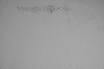 graue Betonwand mit schmutziger, alter, rauer Struktur im oberen Teil des Bildes. Steinwand, Zementwand im Industrial Style als Hintergrund, Tapete, Gestaltungselement, Kunst