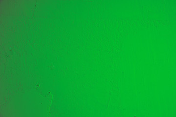 Leuchtend grüner Hintergrund, Steinwand in knalligem grün und leichtem Farbton Verlauf.