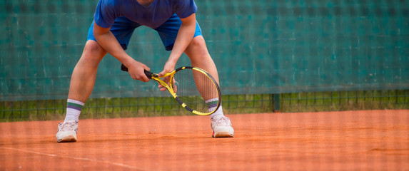 Male tennis player in action on the court