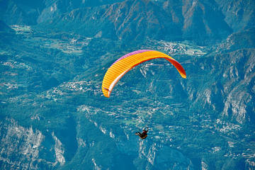 Paraglider flying over the Garda Lake,Panorama of the gorgeous Garda lake surrounded by mountains, Malcesine,Italy