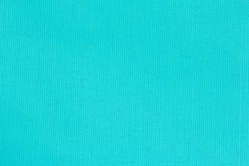 Turquoise canvas texture for background with visible fibers.