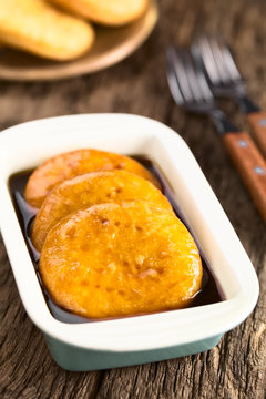 Chilean Sopaipilla pasada deep-fried pastry covered in chancaca cane sugar sauce, a popular snack in autumn and winter (Selective Focus, Focus through the middle of the first sopaipilla)