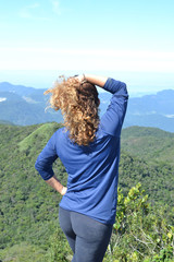 midle age woman on the top of a montain. Concept of success, freedom, joy, self estime, adventure