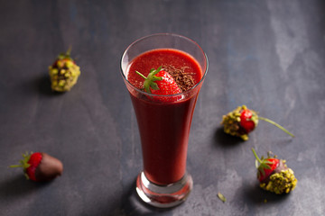 Chocolate strawberry smoothie and chocolate covered berries with chopped pistachios. Healthy drink
