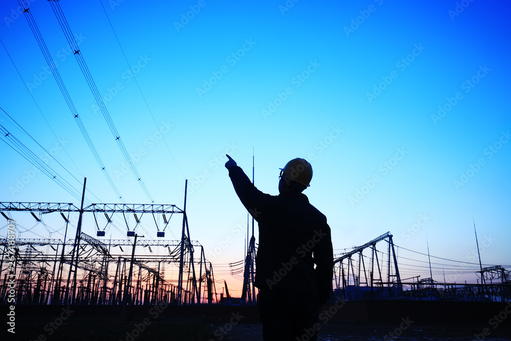 Wall mural electricity workers and pylon silhouette