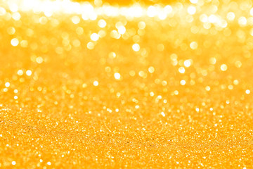sparkles of golden glitter abstract background	