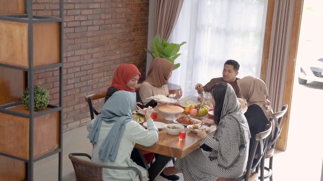 muslim family enjoyed the fast breaking meal in the dining room in the afternoon