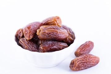 Ramadan food and drinks concept. Close up dates fruit on white background.