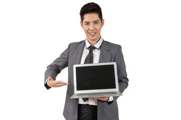 Happy young businessman show laptop in suit looking at camera on white background, isolated concept