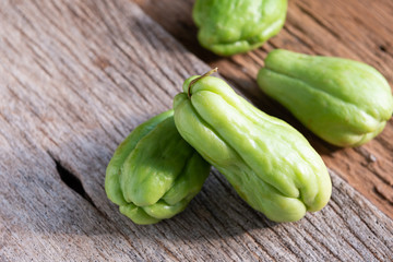 Fresh chayote fruits (Sechium edulis) on wood background