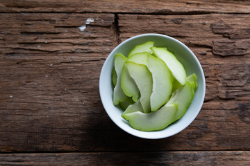 Fresh chayote fruits (Sechium edulis) on wood background