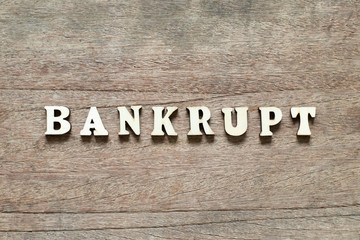 Letter block in word bankrupt on wood background