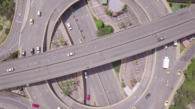 Slow rotating aerial shot of traffic and roads in roundabout Aguacatala in Medellin