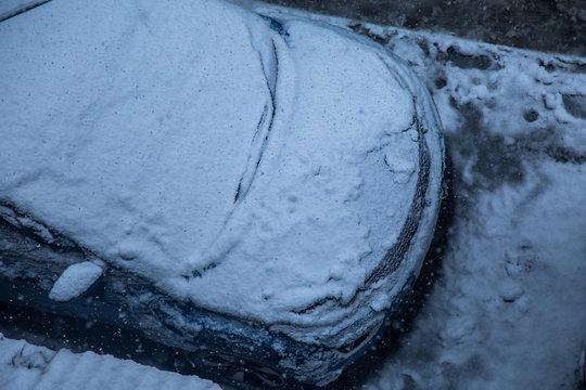 Car covered with a thick layer of snow,top angle. Concept: winter weather and car owner confrontation - Image
