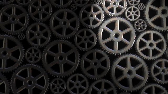 Cinemagraph of one gear going forward and backward amongst many other static gears. A light is pointing on the movement