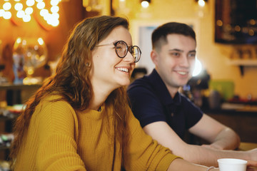 Two young handsome students drinking coffee.