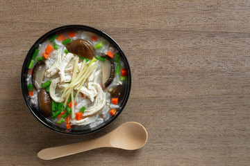 top view of boiled rice with chicken in a ceramic bowl on wooden table. asian homemade style food concept.