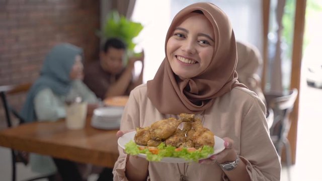beautiful muslim woman with food served for family and friend for dinner together