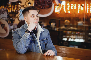 Young handsome guy in a cafe.