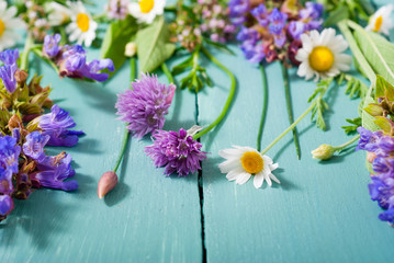 herbal flowers on blue wooden table background