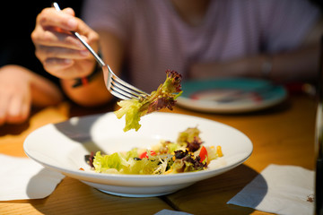 a woman eating fruit salad